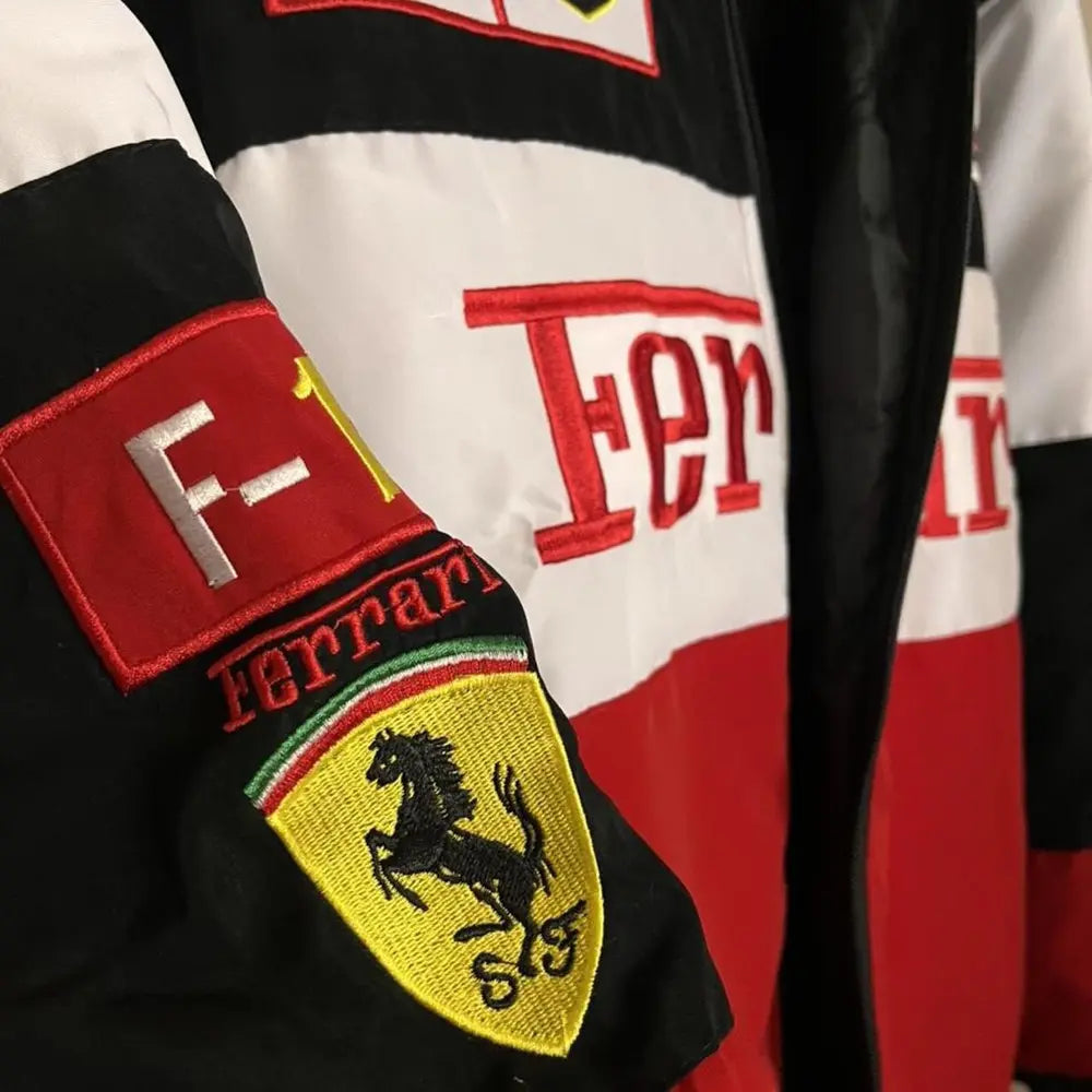 Close-up of a Ferrari logo on a jacket with red, black, and white colors.