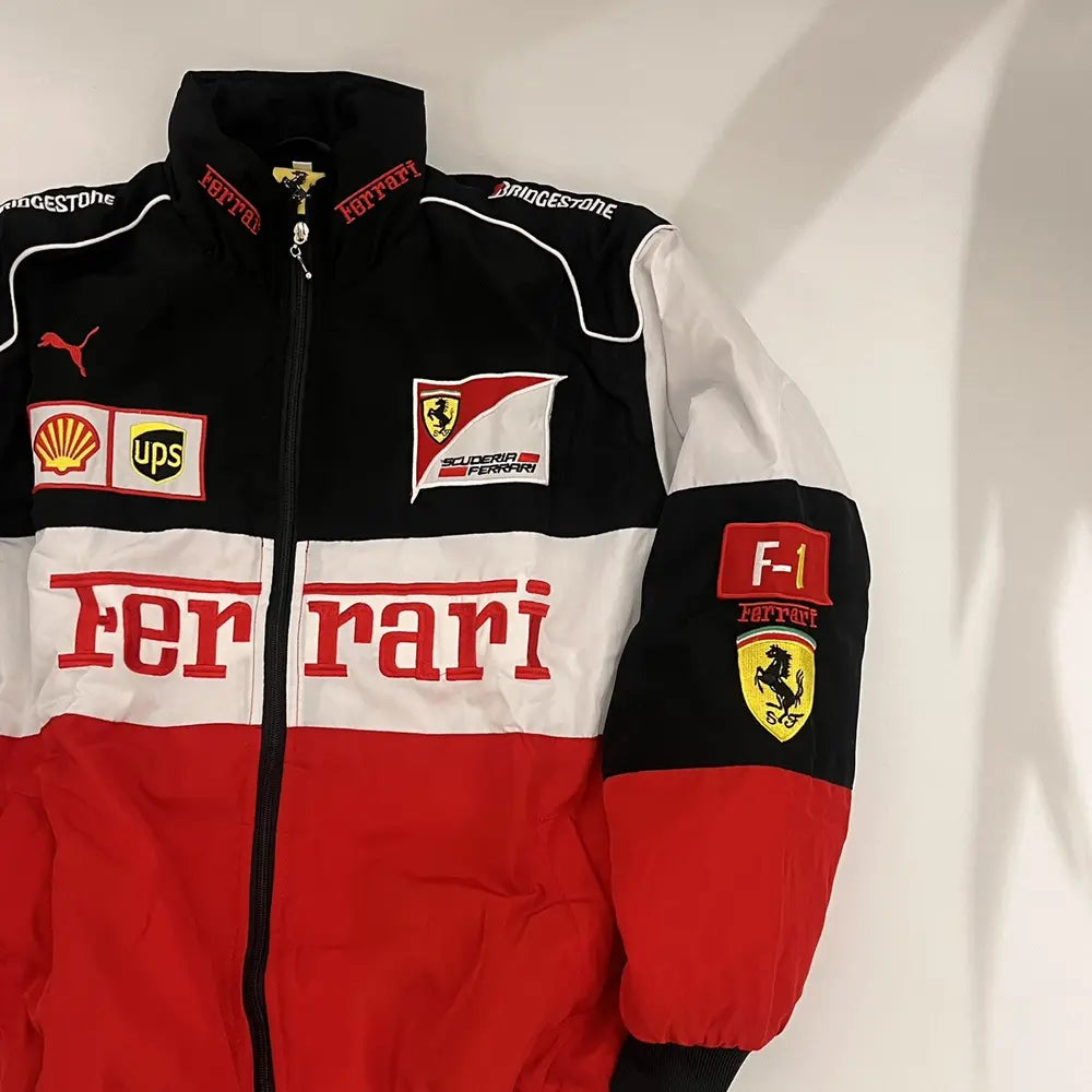 Ferrari racing suit with various logos on a white background