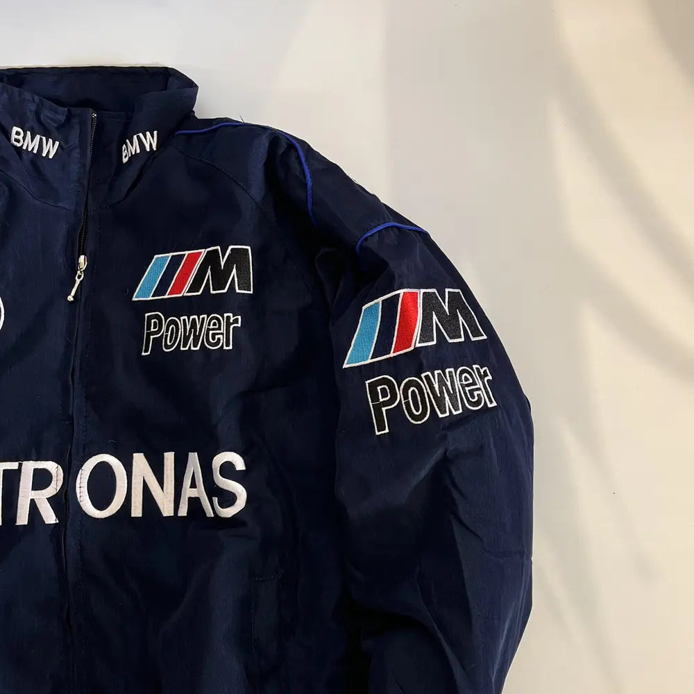 Navy blue jacket with BMW and PETRONAS logos on a light background