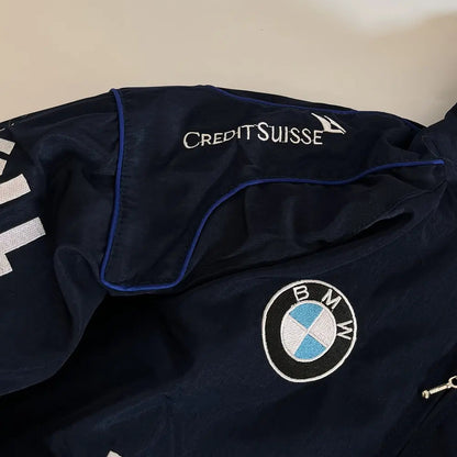 Navy jacket with Credit Suisse and BMW logos on a neutral background