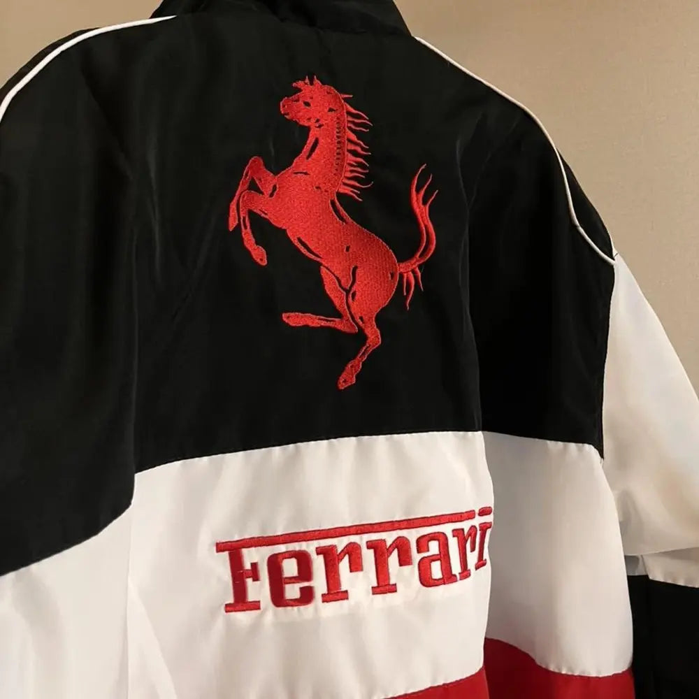 Black, white, and red Ferrari jacket with logo on a beige background