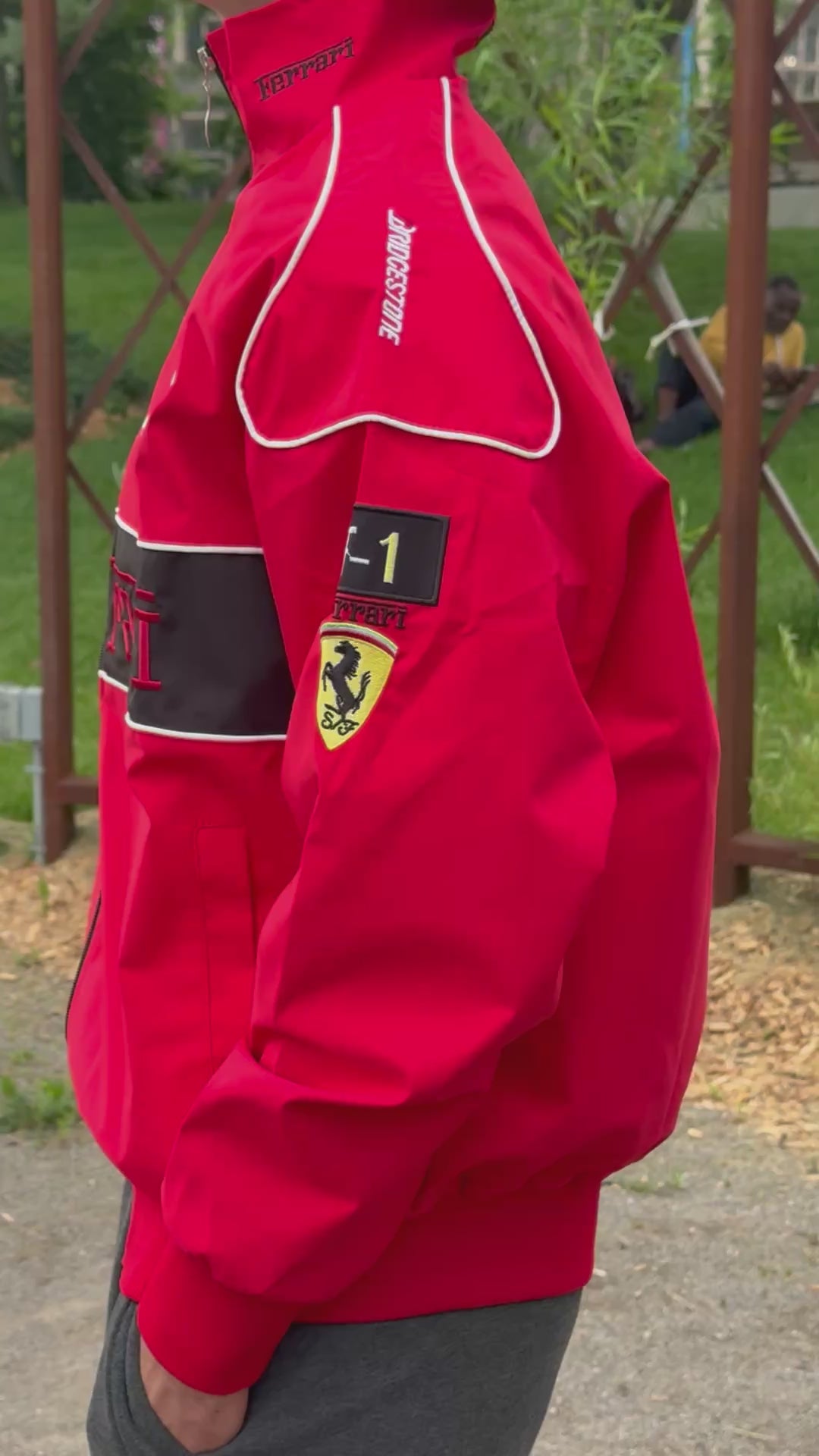 Model wearing Thick Red Ferrari F1 Racing Jacket – Padded Motorsport Streetwear with Embroidered Ferrari Logos, Premium Formula 1 Fan Apparel by Turn One Jackets, showcasing fit, style, and quality